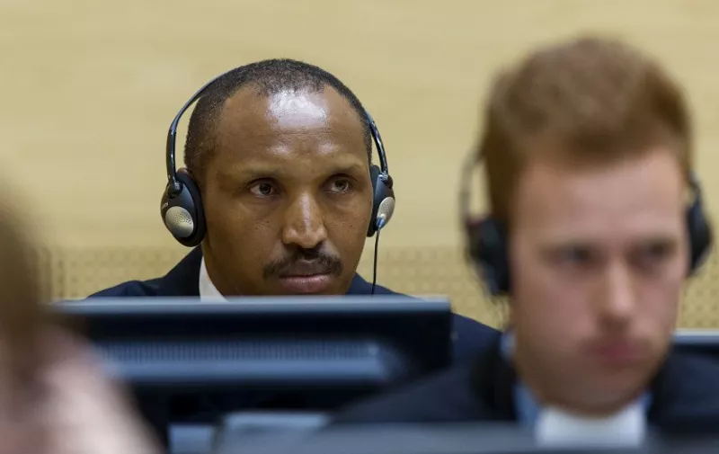 Congolese warlord Bosco Ntaganda sits in the courtroom of the  International Criminal Court (ICC) during the first day of his trial in the Hague, on September 2, 2015. The trial of former Congolese warlord Bosco Ntaganda opened at the International Criminal Court on Wednesday, where the ex-rebel dubbed "The Terminator" faces 18 charges of war crimes and crimes against humanity.  Ntaganda, who surrendered to the US embassy in Kigali in 2013, stands accused of orchestrating hundreds of deaths in savage attacks in the Democratic Republic of Congo, as well as recruiting and raping child soldiers.  AFP PHOTO/ POOL / MICHAEL KOOREN