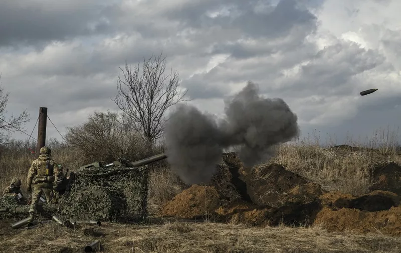 Ukrainian servicemen fire with a 105mm howitzer towards Russian positions near the city of Bakhmut, on March 8, 2023, amid the Russian invasion of Ukraine. (Photo by Aris Messinis / AFP)