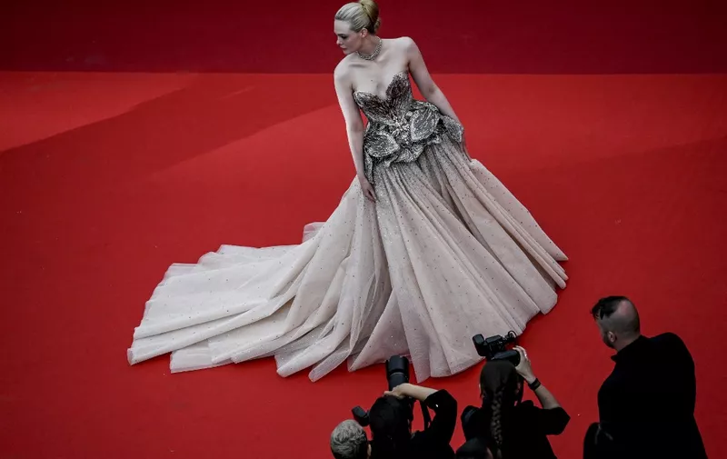 US actress Elle Fanning arrives for the opening ceremony and the screening of the film "Jeanne du Barry" during the 76th edition of the Cannes Film Festival in Cannes, southern France, on May 16, 2023. (Photo by Patricia Moreira / AFP)