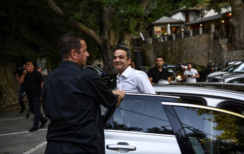 Greece's opposition New Democracy leader Kyriakos Mitsotakis (R) arrives in Makrinitsa during his visit of the central Greek village on July 2, 2019, during his pre-election campaign five days ahead of the general elections. - Greeks vote on July 7, 2019 in a general election that is the first in the country's post-bailout era, which looks set to oust leftist Prime Minister Alexis Tsipras after a record-setting four years in power. (Photo by ARIS MESSINIS / AFP)
