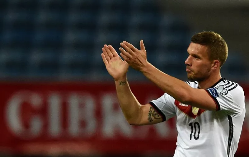 Germany's forward Lukas Podolski cheers fans at the end of the EURO 2016 group D qualifying football match Gibraltar vs Germany at the Algarve stadium in Faro on June 13, 2015. AFP PHOTO/ FRANCISCO LEONG