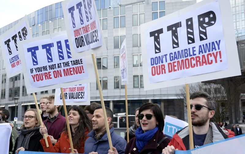 Activists demonstrate against the Transatlantic Trade and Investment Partnership (TTIP) between the EU and the USA outside the European Parliament at Luxembourg Place in Brussels on February 24, 2016.
The TTIP, under negotiation since July 2013, would create the world's biggest free trade zone, removing tariffs and harmonising regulation between the European Union and the United States. Opponents say TTIP is undemocratic and would lead to reckless deregulation at the expense of ordinary citizens. / AFP / THIERRY CHARLIER