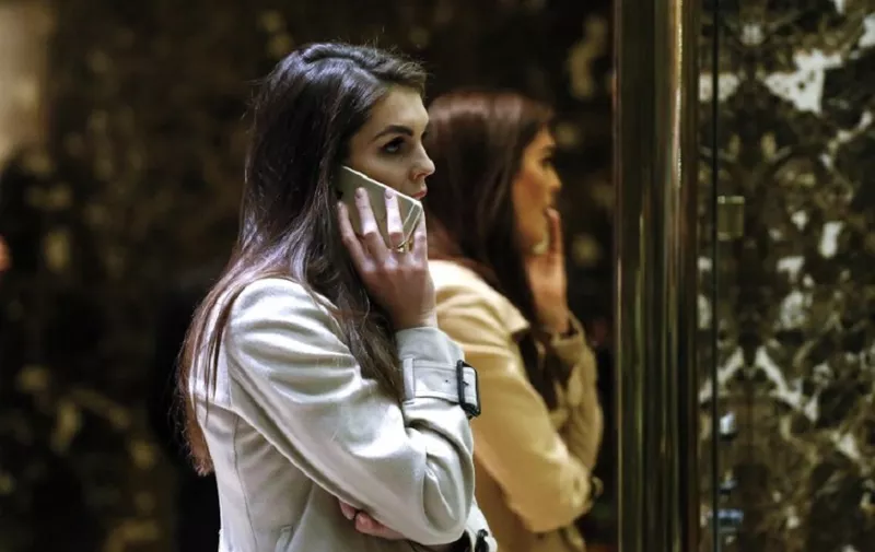 Hope Hicks,communications consultant with the Trump Organization, speaks on the phone at Trump Tower December 12, 2016 in New York. / AFP PHOTO / KENA BETANCUR
