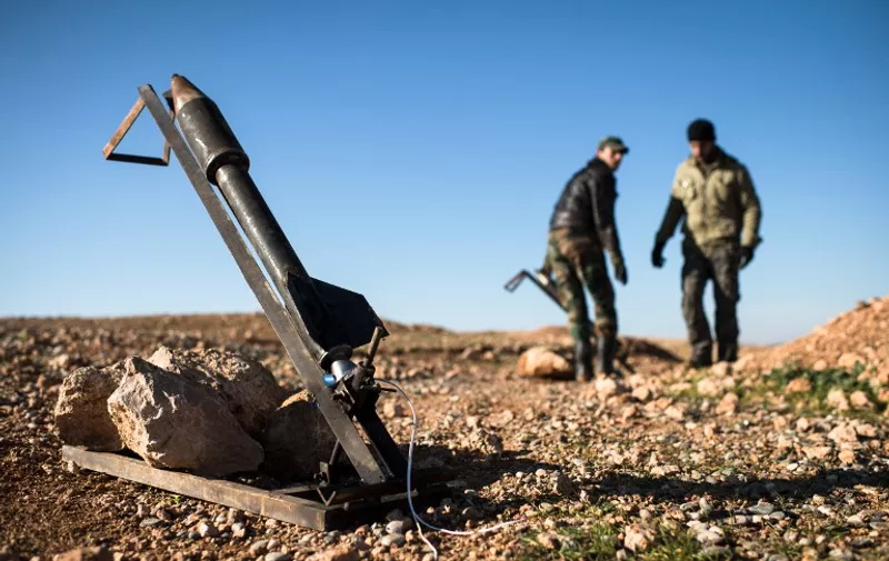 Syrian rebels prepare missiles for launch near the Abu Baker brigade in Albab, 30 kilometres from the northeastern Syrian city of Aleppo, on January 16, 2013. Universities were closed across Syria to mark a day of mourning called after twin blasts tore through an Aleppo campus while students were writing exams, killing at least 87 people. AFP PHOTO / EDOUARD ELIAS / AFP / EDOUARD ELIAS