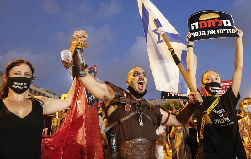 An Israeli protester dressed as a viking chants during a demonstration in Rabin Square in the central coastal city of Tel Aviv, on July 11, 2020, to protest the government's abandonment of the country's self-employed and other sectors after forcing their businesses to close under COVID-19 regulations, according to the organizers. (Photo by Jack GUEZ / AFP)