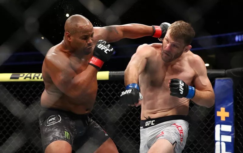 ANAHEIM, CALIFORNIA - AUGUST 17:  Daniel Cormier throws a punch at Stipe Miocic in the first round during their UFC Heavyweight Title Bout at UFC 241 at Honda Center on August 17, 2019 in Anaheim, California. (Photo by Joe Scarnici/Getty Images)