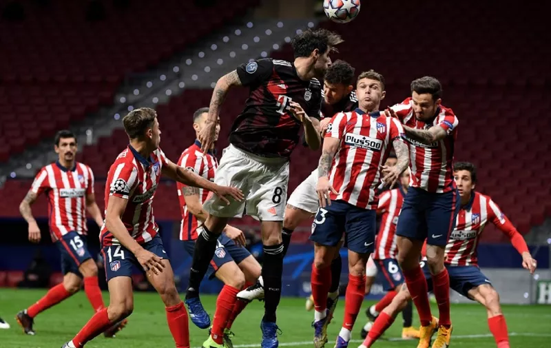 Players jump for the ball during the UEFA Champions League group A football match between Atletico Madrid and Bayern Munich at the Wanda Metropolitano stadium in Madrid on December 1, 2020. (Photo by PIERRE-PHILIPPE MARCOU / AFP)