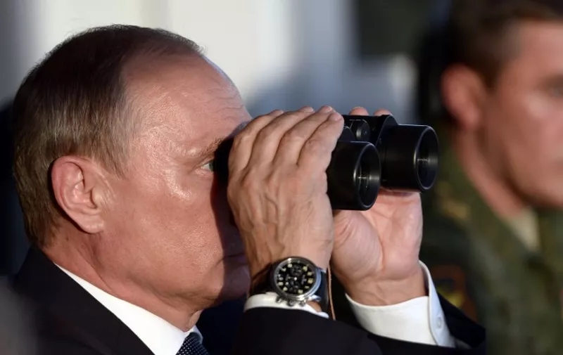 Russia's President Vladimir Putin watches military exercises at the Donguzsky firing ground in the Orenburg region, on September 19, 2015. AFP PHOTO / RIA NOVOSTI / ALEXEI NIKOLSKY