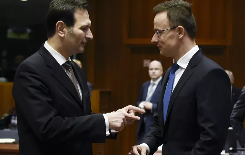 Croatian Minister for Foreign Affairs Miro Kovac (L) talks with Hungary's Minister for External Economy and Foreign Affairs Peter Szijjarto (R) ahead of a meeting of European Union Foreign Affairs Ministers with Iran, Russia, Libya and the Middle East peace process on the agenda at the EU Headquarters in Brussels on March 14, 2016. / AFP PHOTO / JOHN THYS
