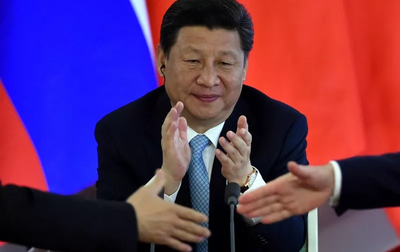 Chinese President Xi Jinping applauds during a signing ceremony after a meeting with his Russian counterpart at the Kremlin in Moscow on May 8, 2015. AFP PHOTO / KIRILL KUDRYAVTSEV