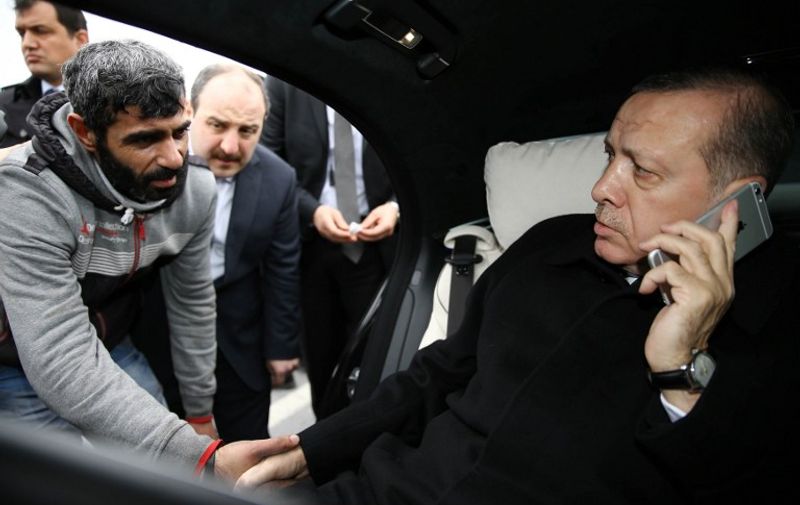Turkish President Recep Tayyip Erdogan (R) shakes hands with a man who was about to allegedly attempt suicide off the Bosporus bridge in Istanbul, on December 25, 2015. 
Turkish President Recep Tayyip Erdogan used his celebrated rhetorical skills to save a life, preventing a man from jumping off Istanbul's Bosphorus Bridge. The man was apparently preparing to jump to his death when Erdogan's motorcade was passing over the bridge linking Europe with Asia after Friday prayers. 
 / AFP / YASIN BULBUL / RESTRICTED TO EDITORIAL USE - MANDATORY CREDIT "AFP PHOTO /TURKISH PRESIDENTIAL PRESS OFFICE/YAS?N BUBUL " - NO MARKETING NO ADVERTISING CAMPAIGNS - DISTRIBUTED AS A SERVICE TO CLIENTS