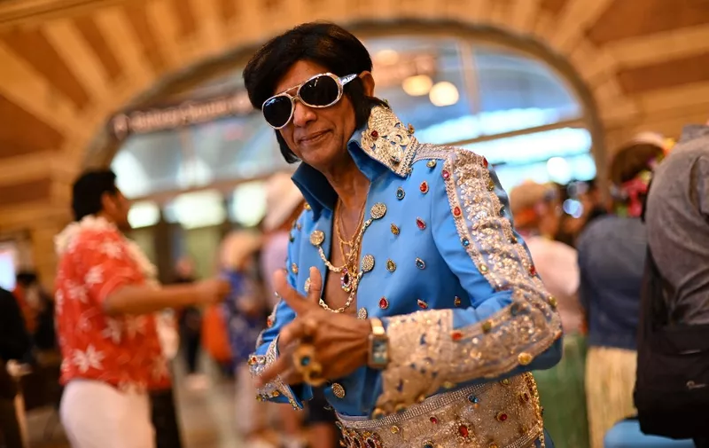 SYDNEY, AUSTRALIA - JANUARY 5: An Elvis impersonator poses for a photograph before boarding the Elvis Express at Central Station in Sydney, Australia, on Thursday, January 5, 2023. Hundreds of Parkes Elvis Festival attendees will board the Elvis Express train from Sydney's Central Station on Thursday for a windy 450-kilometre journey to the central west. Steven Saphore / Anadolu Agency (Photo by STEVEN SAPHORE / ANADOLU AGENCY / Anadolu via AFP)