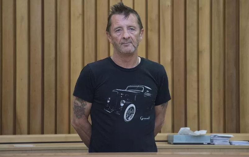Former AC/DC drummer Phil Rudd stands in the dock as faces charges at the High Court in Tauranga, New Zealand on November 26, 2014. The 60-year-old Australian, who has lived in Tauranga for over 30 years, hit the headlines on November 6 when he appeared in court accused of attempting to hire a hitman to [&hellip;]