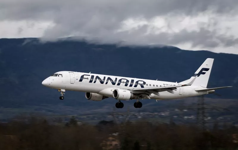 An Embraer 190 commercial plane with registration OH-LKI of Nordic carrier Finnair is seen landing at Geneva Airport on March 11, 2019 in Geneva. (Photo by Fabrice COFFRINI / AFP)