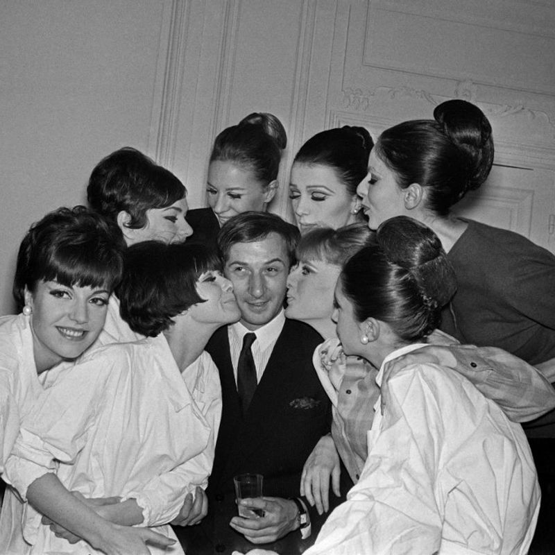 Pictura taken on January 28, 1965 at Paris showing French fashion designer Marc Bohan surrounded and gratulated by the fashion models after the Dior Spring-Summer 1965 collection's presentation. (Photo by AFP)