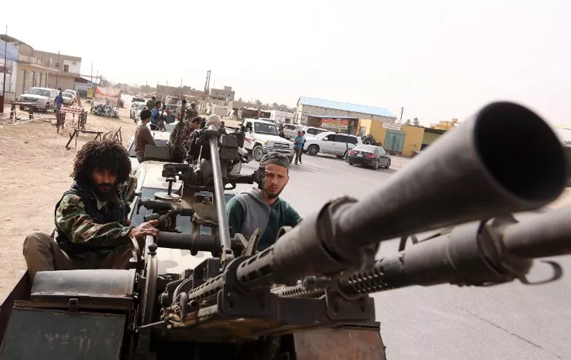 Members of a brigade loyal to the Fajr Libya (Libya Dawn), an alliance of Islamist-backed fighters, drive pick up trucks mounted with machine guns during a military parade following battles against the Islamic State (IS) group, in the city of Sabratha, west of the capital Tripoli, on February  28, 2016.
On February 19, a US air strike near Sabratha targeted a suspected IS training camp, killing 50 people. / AFP / MAHMUD TURKIA