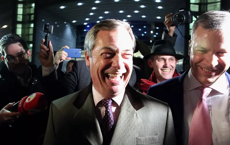 Britain's Brexit Party leader Nigel Farage (C) leaves the European Parliament after a plenary session to vote on the Brexit deal in Brussels  on January 29, 2020. - The European Parliament on January 29 voted overwhelmingly to approve the Brexit deal with London, clearing the final hurdle for Britain's departure from the EU. (Photo by François WALSCHAERTS / AFP)
