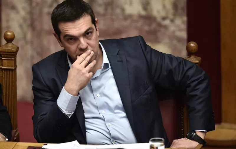 Greek Prime Minister Alexis Tsipras attends a parliament session in Athens on March 30, 2015. The EU warned Monday that Greece and its creditors had yet to hammer out a new list of reforms despite talks lasting all weekend aimed at staving off bankruptcy and a euro exit. AFP PHOTO / ARIS MESSINIS