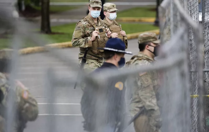 Members of the Washington National Guard stand outside the state Capitol in Olympia, Washington on January 17, 2021 during a nationwide protest called by anti-government and far-right groups supporting US President Donald Trump and his claim of electoral fraud in the November 3 presidential election. - The FBI warned authorities in all 50 states to prepare for armed protests at state capitals in the days leading up to the January 20 presidential inauguration of President-elect Joe Biden. (Photo by Jason Redmond / AFP)