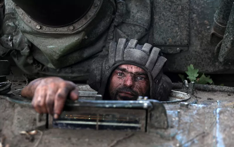 A Ukrainian tank driver sits in his tank at the front line in the Donetsk region on August 19, 2022, amid Russia's invasion of Ukraine. (Photo by ANATOLII STEPANOV / AFP)