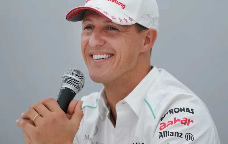 Mercedes driver Michael Schumacher of Germany smiles as he answers questions during a press conference in the Suzuka circuit on October 4, 2012 one day before the start of the Formula One Japanese Grand Prix.    AFP PHOTO/Toru YAMANAKA (Photo by TORU YAMANAKA / AFP)