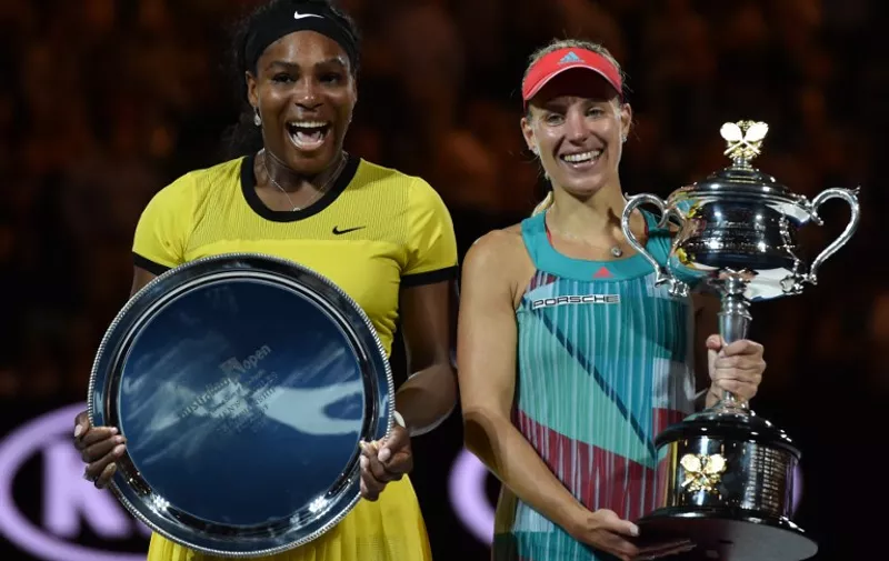 Germany's Angelique Kerber (R) holds The Daphne Akhurst Memorial Cup as she celebrates after victory her women's singles final match against Serena Williams of the US (L) on day thirteen of the 2016 Australian Open tennis tournament in Melbourne on January 30, 2016. AFP PHOTO / SAEED KHAN-- IMAGE RESTRICTED TO EDITORIAL USE - STRICTLY NO COMMERCIAL USE / AFP / SAEED KHAN