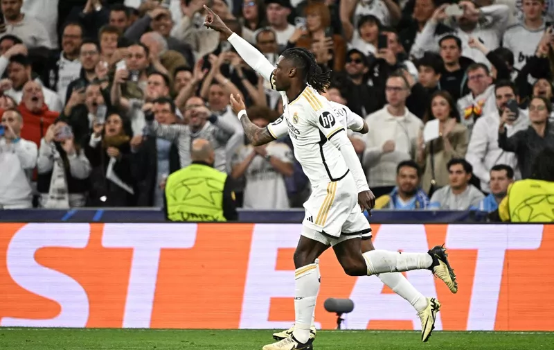 Real Madrid's French midfielder #12 Eduardo Camavinga (C) celebrates scoring his team's first goal during the UEFA Champions League quarter final first leg football match between Real Madrid CF and Manchester City at the Santiago Bernabeu stadium in Madrid on April 9, 2024. (Photo by JAVIER SORIANO / AFP)
