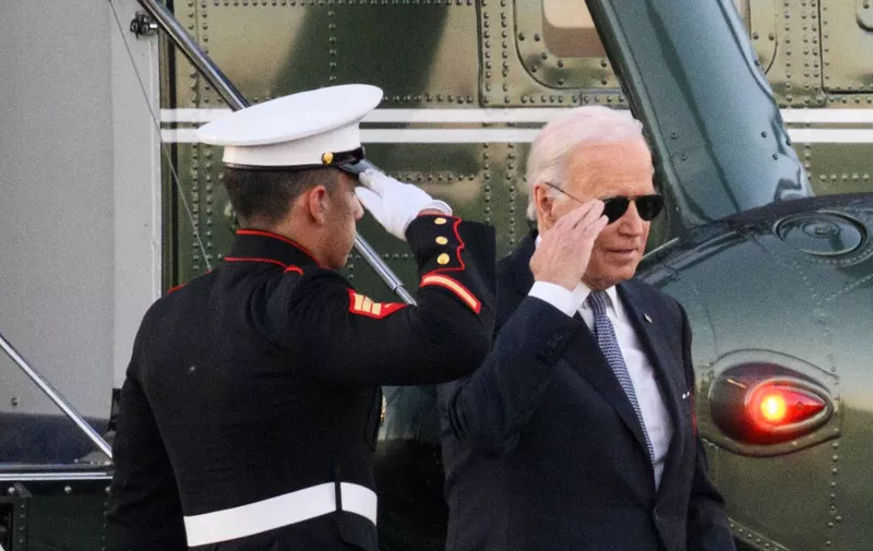 US President Joe Biden salutes as he steps off Marine One upon arrival at Gordons Pond in Cape Henlopen State Park in Lewes, Delaware on October 21, 2022. - Biden is heading to his beach house in Rehoboth Beach, Delaware to spend the weekend. (Photo by Mandel NGAN / AFP)