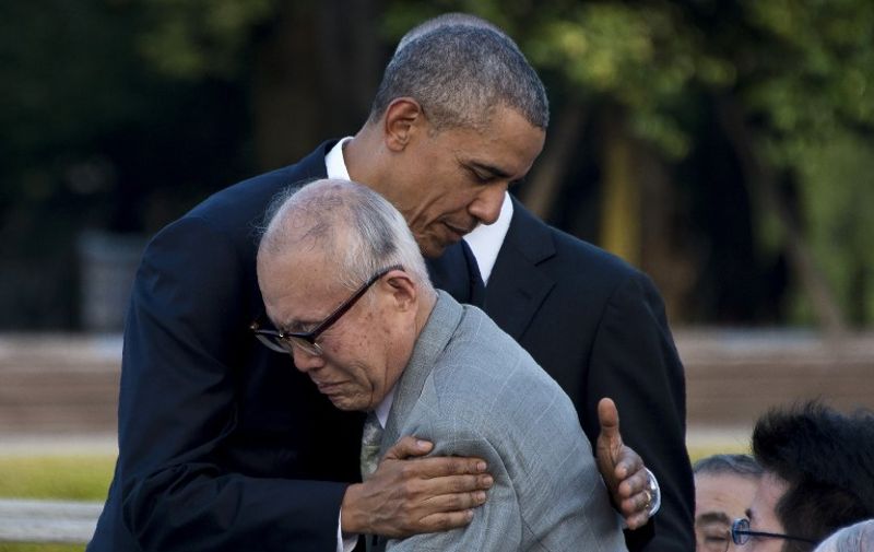 US President Barack Obama hugs Shigeaki Mori (front), a survivor of the 1945 atomic bombing of Hiroshima, during a visit to the Hiroshima Peace Memorial Park on May 27, 2016.
Obama on May 27 paid moving tribute to victims of the world's first nuclear attack.
  / AFP PHOTO / JIM WATSON
