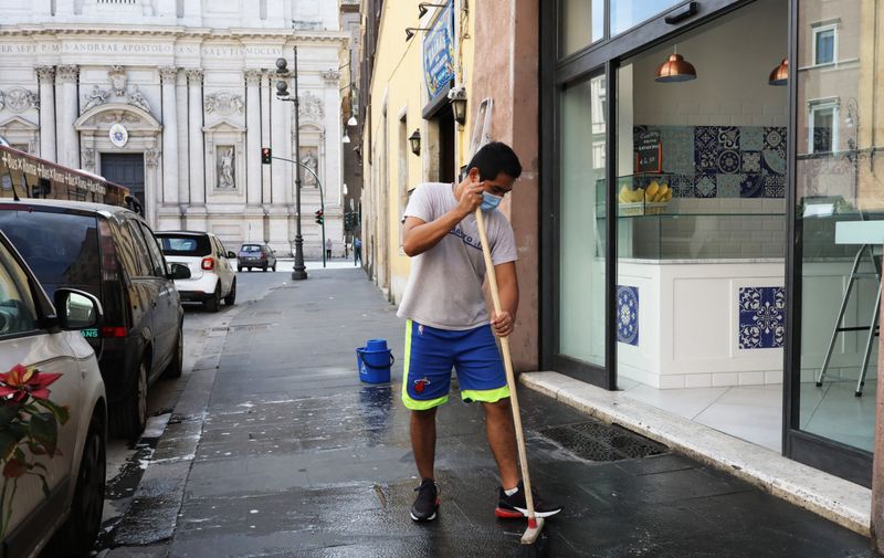 ROME, ITALY - MAY 15: An employee sweeps the space in front of his pizzeria in view of the reopening on May 15, 2020 in Rome, Italy.  Italy was the first country to impose a nationwide lockdown to stem the transmission of the Coronavirus (Covid-19), and its restaurants, theaters and many other businesses remain closed. (Photo by Marco Di Lauro/Getty Images)