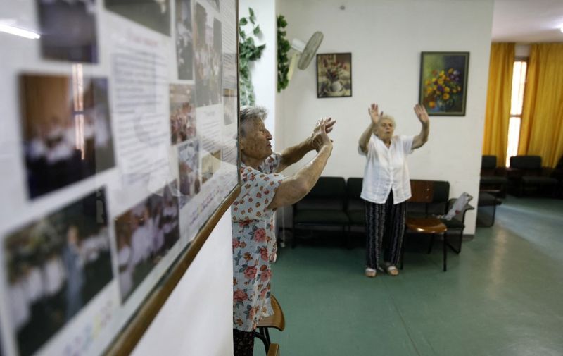 Israeli elderly women take part in a morning workout in a former hotel turned into a social housing building for elderly Israelis from the former Soviet Union, in Jerusalem on September 4, 2019. In a former hotel turned social housing building for elderly Israelis from the former Soviet Union, one politician remains more popular than all others. "Here, the vast majority of people vote (Avigdor) Lieberman," said Nadejda Yermononok, 75, referring to the gruff hardline leader of the nationalist Yisrael Beitenu party. (Photo by MENAHEM KAHANA / AFP)