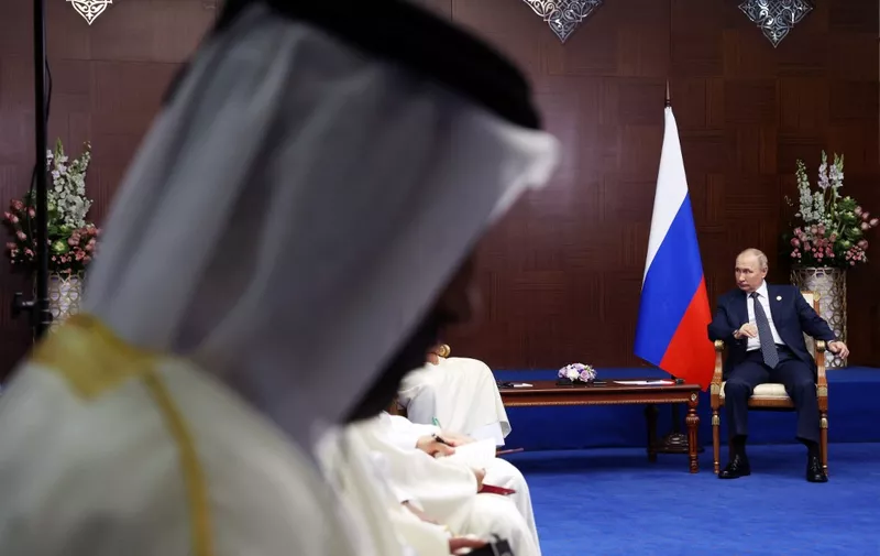 Russian President Vladimir Putin meets with Qatari Emir Sheikh Tamim bin Hamad Al-Thani on the sidelines of the Sixth Summit of the Conference on Interaction and Confidence Building Measures in Asia (CICA) in Astana on October 13, 2022. (Photo by Vyacheslav PROKOFYEV / SPUTNIK / AFP)