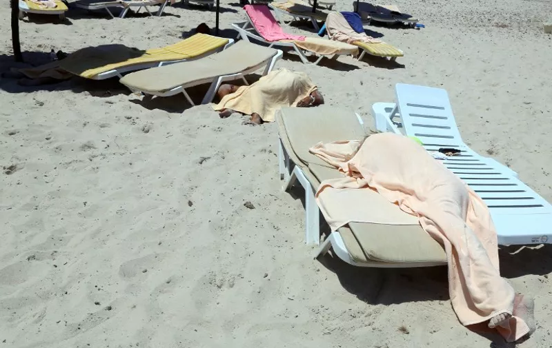 GRAPHIC CONTENT
Covered bodies of victims of a mass-shooting are seen in the resort town of Sousse, a popular tourist destination 140 kilometres (90 miles) south of the Tunisian capital, following the attack on June 26, 2015. At least 27 people, including foreigners, were killed in a mass shooting at a Tunisian beach resort packed with holidaymakers, in the North African country's worst attack in recent history. AFP PHOTO / FETHI BELAID