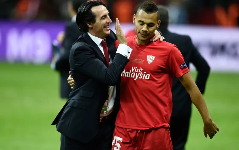 Sevilla's coach Unai Emery and Sevilla's French defender Timothee Kolodziejczak celebarte after the UEFA Europa League final football match between FC Dnipro Dnipropetrovsk and Sevilla FC at the Narodowy stadium in Warsaw, Poland on May 27, 2015. Sevilla FC won 2-3.      AFP PHOTO / ODD ANDERSEN
