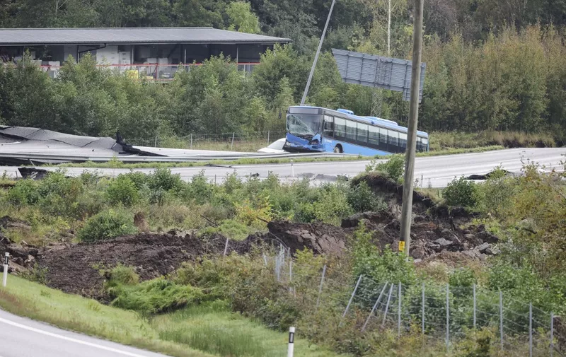 E6 near Stenungsund is closed in both directions after persistent rain has caused a large landslide where several cars and a buses went down. Three people are said to be injured. September 23, 2023.
Photo: Adam Ihse / TT / code 9200 (Photo by ADAM IHSE / TT NEWS AGENCY / TT News Agency via AFP)