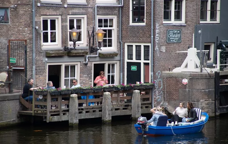 Daily life in the canals of Amsterdam in the Netherlands with people enjoying drinks next to the water or having a boat tour. The 17th century canal ring area, known as &quot;Venice of the North&quot; is a UNESCO World Heritage Site in the Dutch capital. The scenes with the overcrowded tourists didn't occur in April as there were travel restrictions applied due to Covid-19 Coronavirus pandemic. Amsterdam, the Netherlands on April 28, 2021.
Daily Life In Amsterdam, Netherlands - 28 Apr 2021,Image: 628526544, License: Rights-managed, Restrictions: , Model Release: no, Credit line: Profimedia