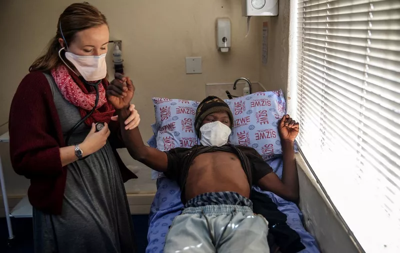Doctor Pauline Howell (L) consults a patient known as Nxumalo, currently on the NIX treatment, at the Sizwe Tropical Diseases Hospital in Johannesburg, South Africa, on August 5, 2019. - A new treatment was approved on August 14, 2019 by the US Food and Drug Administration. 
It cures highly drug-resistant strains of tuberculosis and drastically shorten the treatment period. The announcement was especially welcomed in South Africa, one of the countries with the highest number of TB cases. Of the more than 1.6 million TB deaths recorded every year, more than 75,000 are in South Africa alone. In 2017, South Africa recorded more than 322,000 active TB cases. (Photo by Michele Spatari / AFP)