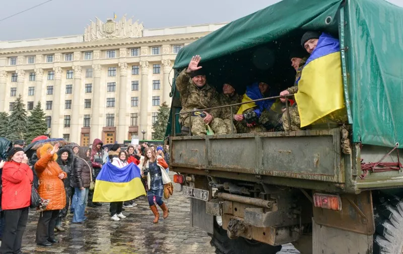 Ukrainian army serviceman waves during a farewell ceremony in the center of Kharkiv on April 4, 2015 before their departure for the east of the country to take part in anti-terrorists operation (ATO). Isolated clashes in the separatist-held east of Ukraine continue to undermine a ceasefire aimed at ending a year-long war. AFP PHOTO/SERGEY BOBOK