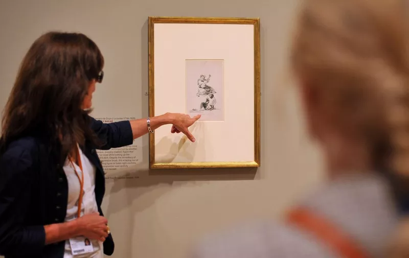 A visitor looks at a work of art entitled 'Cantar y Bailar' (Singing and Dancing)' by Spanish artist Francisco de Goya y Lucientes during a press view for the' The Spanish Line: Drawings From Ribera To Picasso' exhibition at the Courtauld Gallery in central London, on October 12, 2011. The exhibition presents highlights of the gallery's collection of Spanish drawings and will run from October 13, 2011 to January 15, 2012.  AFP PHOTO / BEN STANSALL (Photo by BEN STANSALL / AFP)