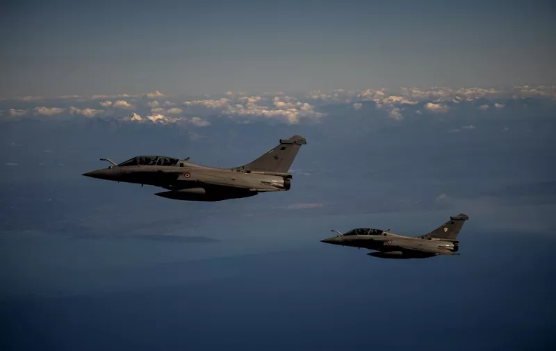Two French Air Force Rafale fighter jets fly over Greece during a joint military drill with Greece Air Force as part of French Air Force's mission "Skyros 2021" on February 3, 2021. (Photo by ANGELOS TZORTZINIS / AFP)