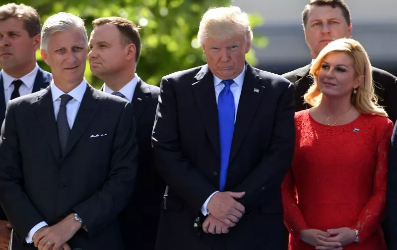 (From L) King Philippe - Filip of Belgium , US President Donald Trump and Croatian President Kolinda Grabar-Kitarovic pose as they arrive for the unveiling ceremony of the Berlin Wall monument, during the NATO (North Atlantic Treaty Organization) summit at the NATO headquarters, in Brussels, on May 25, 2017. / AFP PHOTO / Emmanuel DUNAND