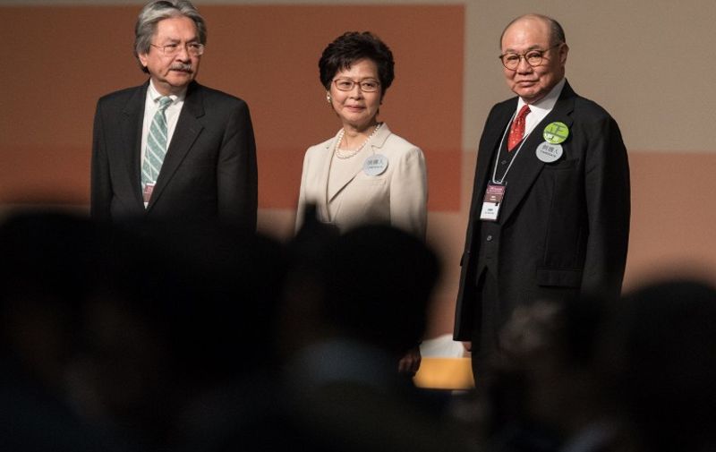 Hong Kong chief executive candidates (L-R) John Tsang,  Carrie Lam and Woo Kwok-hing look on after Lam was announced the winner in the Hong Kong chief executive election in Hong Kong on March 26, 2017.
Beijing favourite Carrie Lam was selected as Hong Kong's new leader by a mainly pro-China committee, in an election dismissed as a sham by democracy activists who fear the loss of the city's cherished freedoms. / AFP PHOTO / DALE DE LA REY