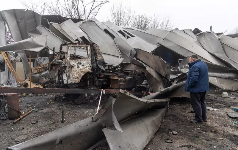 A man inspects a municipal car repair facility damaged as a result of a drone attack in Odesa on December 13, 2023, amid Russian invasion of Ukraine. (Photo by Oleksandr GIMANOV / AFP)