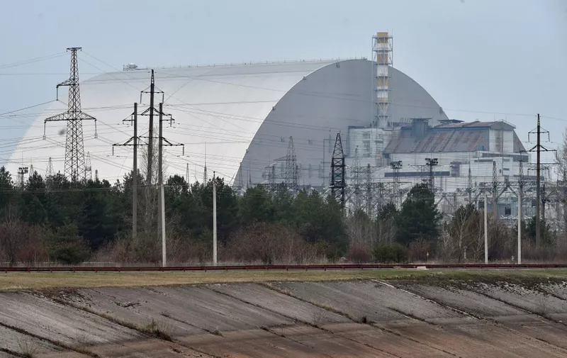 (FILES) A file picture taken on April 13, 2021 shows the giant protective dome built over the sarcophagus covering the destroyed fourth reactor of the Chernobyl Nuclear Power Plant ahead of the upcoming 35th anniversary of the Chernobyl nuclear disaster. - Ukraine's Chernobyl nuclear plant says 'completely halted' over Russian offensive. (Photo by Sergei SUPINSKY / AFP)