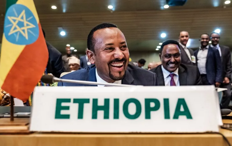 Ethiopia's Prime Minister Abiy Ahmed (C) smiles before a High Level Consultation Meeting with African leaders on DR Congo election at the AU headquarters in Addis Ababa, on January 17, 2019. - Chairperson of the African Union Commission on January 17, 2019 said "serious doubts" remain over the results of last month's election in the DR Congo. (Photo by EDUARDO SOTERAS / AFP)