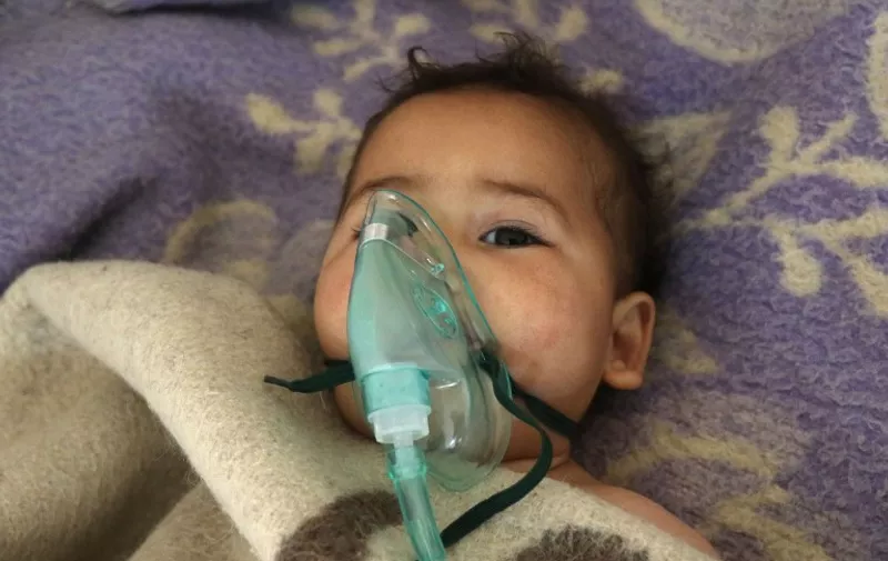 A Syrian child receives treatment at a small hospital in the town of Maaret al-Noman following a suspected toxic gas attack in Khan Sheikhun, a nearby rebel-held town in Syrias northwestern Idlib province, on April 4, 2017.
Warplanes carried out a suspected toxic gas attack that killed at least 35 people including several children, a monitoring group said. The Syrian Observatory for Human Rights said those killed in the town of Khan Sheikhun, in Idlib province, had died from the effects of the gas, adding that dozens more suffered respiratory problems and other symptoms.
 / AFP PHOTO / Mohamed al-Bakour / ADDING INFORMATION IN CAPTION