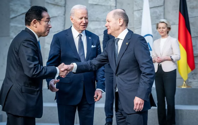 German Chancellor Olaf Scholz (R) greets Japan's Prime Minister Fumio Kishida (L), US President Joe Biden (2L) next to European Commission President Ursula von der Leyen during a NATO summit at the alliance's headquarters in Brussels on March 24, 2022. (Photo by Michael Kappeler / POOL / AFP)
