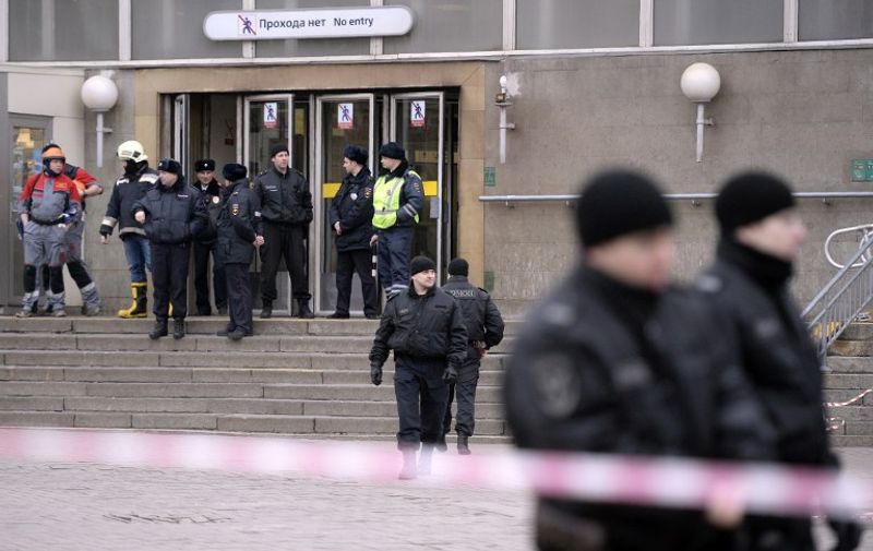 Police officers guard the entrance to Sennaya Square metro station in Saint Petersburg on April 3, 2017.
Russia's Investigative Committee said Monday it was probing a suspected "act of terror" after a blast in the Saint Petersburg metro killed about 10 people and injured dozens.  / AFP PHOTO / Olga MALTSEVA