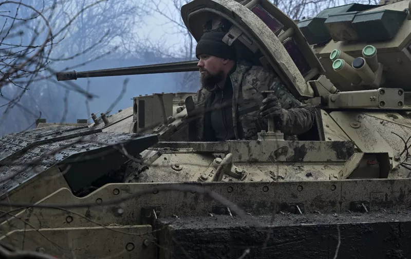 A Ukrainian serviceman of the 47th Mechanized Brigade prepares for combat a Bradley fighting vehicle, not far away from Avdiivka, Donetsk region on February 11, 2024, amid the Russian invasion of Ukraine. (Photo by Genya SAVILOV / AFP)