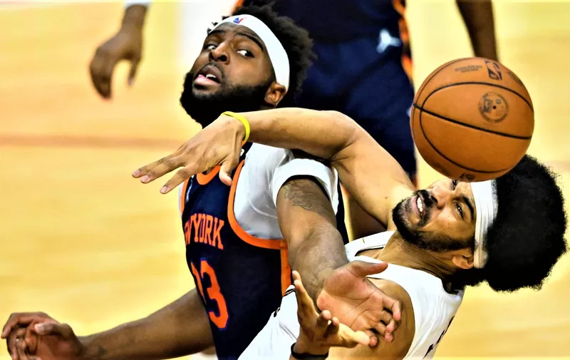 Apr 15, 2023; Cleveland, Ohio, USA; New York Knicks center Mitchell Robinson (23) and Cleveland Cavaliers center Jarrett Allen (31) reach for a loose ball in the second quarter of game one of the 2023 NBA playoffs at Rocket Mortgage FieldHouse. Mandatory Credit: David Richard-USA TODAY Sports